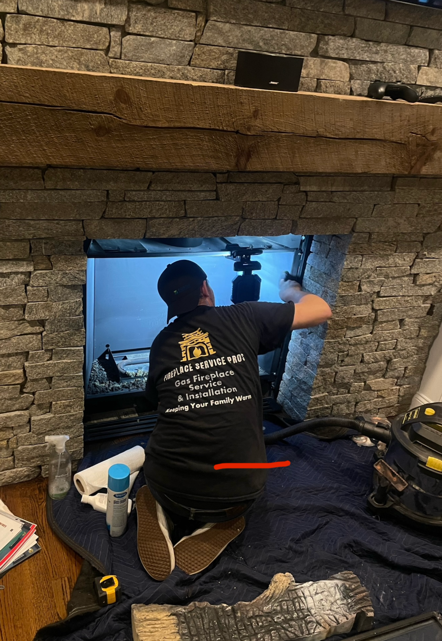 Fireplace Pros technician servicing a gas fireplace
