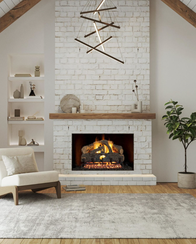 Vented gas log set in white brick fireplace